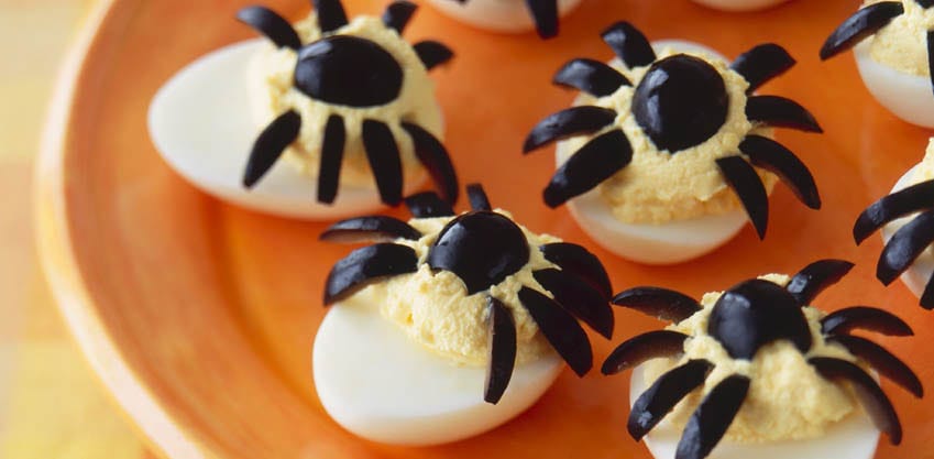 Per l'aperitivo di Halloween, uova decorate con ragnetti di olive nere