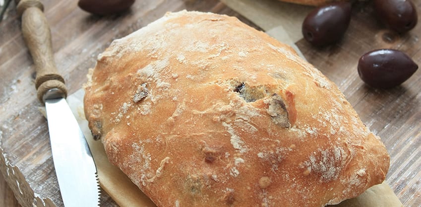 un tagliere con due bocconcini di pane con olive